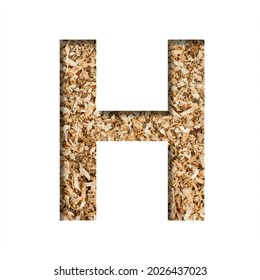 Sawdust Wood Font. The Letter H Cut Out Of Paper On The Background Of Sawdust Or Small Shavings Of A Fruit Tree. Decorative Alphabet For Handmade Or Small Production, Font Collection.