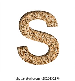 Sawdust Wood Font. The Letter S Cut Out Of Paper On The Background Of Sawdust Or Small Shavings Of A Fruit Tree. Decorative Alphabet For Handmade Or Small Production, Font Collection.