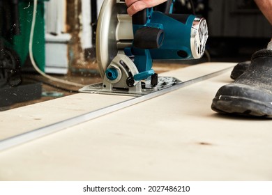 Sawing Plywood By Circular Saw. Home Repair. Hand Tool. Man Hold Equipment. Building Process. Woodworking. Safety Engineering. Without Gloves. Copy Space. Indoor. Cutting Material. Rental Instrument.