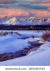 Sawtooth Mountains with small stream and split rail fence.  An early, very cold mornig near Stanley, Idaho