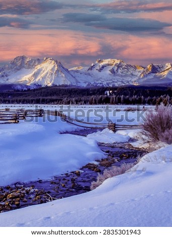 Sawtooth Mountains with small stream and split rail fence.  An early, very cold mornig near Stanley, Idaho