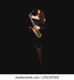 Saxophone Player. Jazz Musician Saxophonist Woman Playing Sax Player Isolated On Black