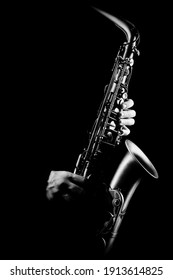 Saxophone player. Saxophonist with alto sax closeup isolated on black. Jazz music instrumens - Shutterstock ID 1913614825