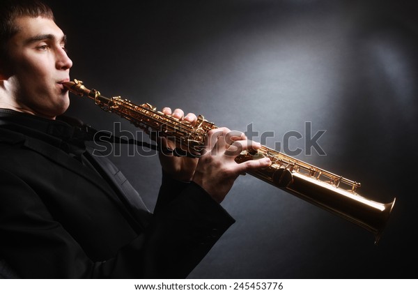 Saxophone player. Saxophonist with soprano\
sax Man with musical\
instruments