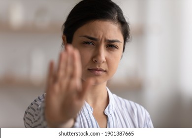 I say enough. Portrait of desperate indian woman showing stop gesture to any manifestations of racial gender discrimination. Strong hindu lady look at camera defend female right for free determination