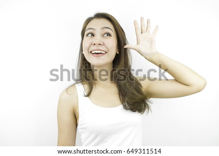Say hello or good bye, thinking positive and looking front with happy smiling face, posing in white casual dress, posing by asian woman at studio in grey background.