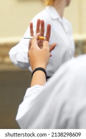 Saying No. Cropped Shot Of A Young Female Studentd Turning Down Cigarettes In Response To Peer Pressure.