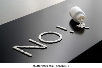 Saying No To Drugs Or Refuse To Use Medicine. Anti Doping Or Against Medical Violation Or Unethical Pharmaceutical Business. Zero Tolerance Or Rehab Concept With Pills Spilled On Table From Bottle