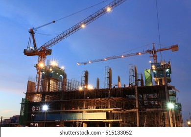 Scaffolding construction site at dusk with moving crane - Powered by Shutterstock