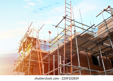 Scaffolding erected around houses in a new housing development - Powered by Shutterstock