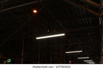 Scaffolding Over A Busy Side Walk. Shot Using Converging Lines.