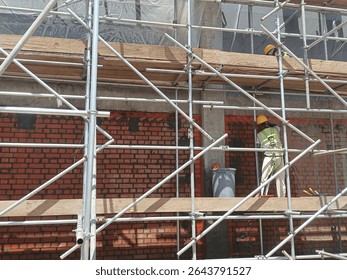 Scaffolding platform for brickwork inside a column and .beam frame providing a safe and stable working surface at required heights for masons. It is made of steel and timber material