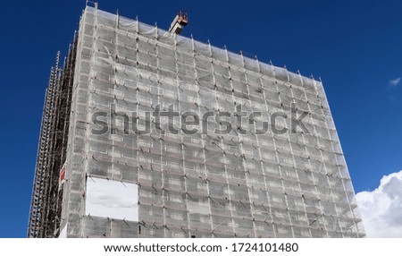 Scaffolding providing platforms for work in progress on a new apartment block