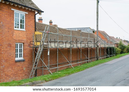 Scaffolding and roof repairs, replacing roof tiles on a rural house in Buckinghamshire, UK