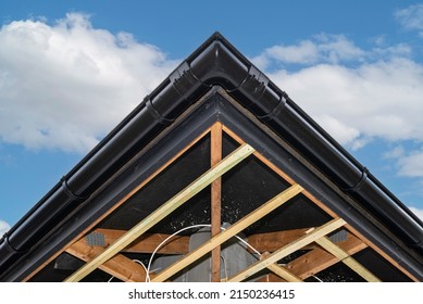 Scaffolding With Three Rows Of Wooden Battens For Attaching The PVC Soffit, Visible Cables For Lighting.