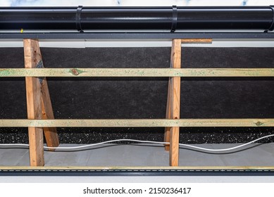 Scaffolding With Three Rows Of Wooden Battens For Attaching The PVC Soffit, Visible Cables For Lighting.