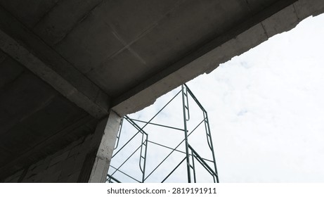 Scaffolding underconstruction with cloudy sky.