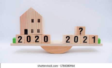 Scale Comparing 2020 And 2021 Housing Market Trends, Question On Real Estate Economics Future Plan And Property Value Analysis. Business Concept Of Forecasting Financial Effect From Coronavirus Crisis