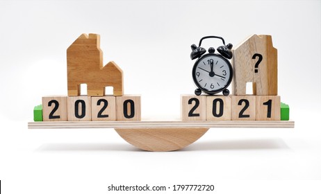 Scale Comparing 2020 And 2021 Housing Market Trends, Is It The Best Time To Buy House Or Property Investment In 2021. Real Estate Concept After Economic Impact From Coronavirus Crisis.