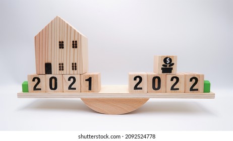 Scale Comparing 2021 And 2022 Housing Market Value. Business Concept Of Property Trends. When Is The Best Time To Buy House Or Real Estate Investment After Financial Impact From Coronavirus Crisis.