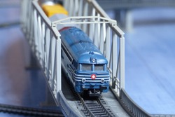 Scale Model Of A Blue Diesel Train Over A Bridge