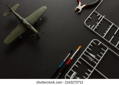 Scale model of a fighter aircraft with details and tools. Plastic assembly kit
