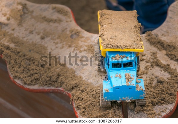 Scale model of plastic\
truck with sand