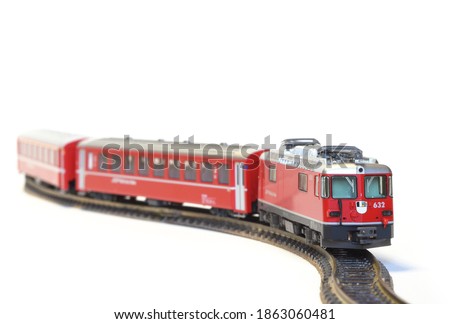 Scale model of red train isolated on white