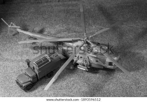 Scale models. Assembled plastic helicopter and\
car models.