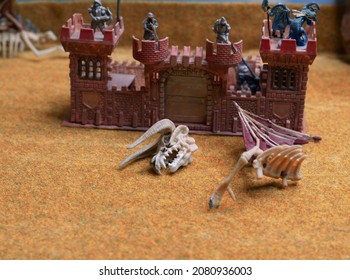 Scale models. Dragon's head at the gates of the knight's castle. Models and figures for the war game. Dragons and warriors 