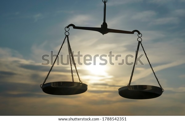 Scales of\
Justice background - legal law concept. a balance is hand-held, sky\
is the background.zodiac sign -\
libra