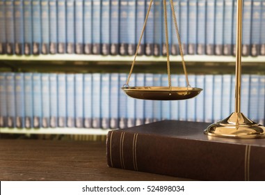 Scales Of Justice On Law Books In Library Of Law Firm. Legal Education Concept.