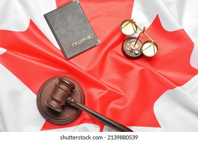 Scales of justice, passport and judge's gavel on Canadian flag