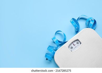 Scales and measuring tape on light blue background, flat lay. Space for text