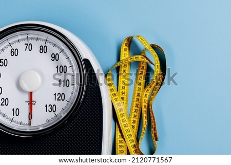 Scales and measuring tape. top view. the concept of excess weight