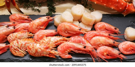 Scallops, Shrimp, Crab Legs On A Dark Background