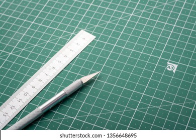 Scalpel For Cutting Paper And Ruler On Cutting Mat In Study