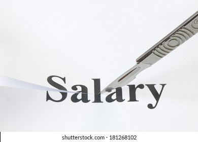 Scalpel Cutting Through The Word Salary. Concept Denoting A Cut In Income Or Salary Caused By Economic Troubles And A Lowering Of Standard Of Living.