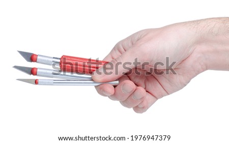 Scalpel knife with replaceable blade in hand on white background isolation