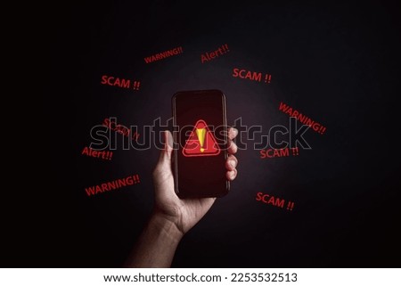 Scam alert on smartphone concept, virus hacker internet security, Businessman holding smart phone. Scam money from banking apps, Spam Email Pop-up Warning.