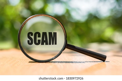 SCAM Text On Magnifier Glass. Scam Alert Word Concept, A