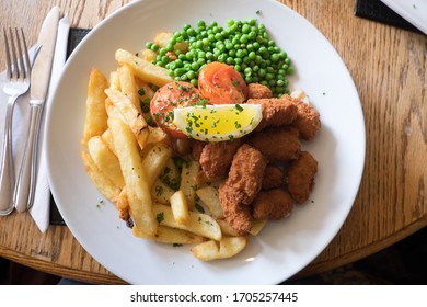 Scampi, Chips And Peas: Traditional British Pub Meal For Lunch - Elevated View