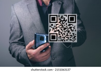 Scan the QR code icon. Digital scan of qr code. man presses on the screen holding the phone in his hand