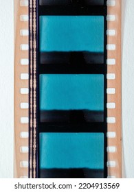 Scan Of Real 35mm Movie Film Strip With Sound Waves And Empty Or Blank Frames On White Background, Just Blend In Your Work Here, Movie Cine Still Frame.