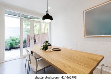 Scandi Styled Dining Room With Closed French Doors In Luxury Apartment Home