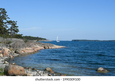 Scandinavian Archipelago In Summertime. Blue Baltic Sea. White Sailing Boat Passing. 