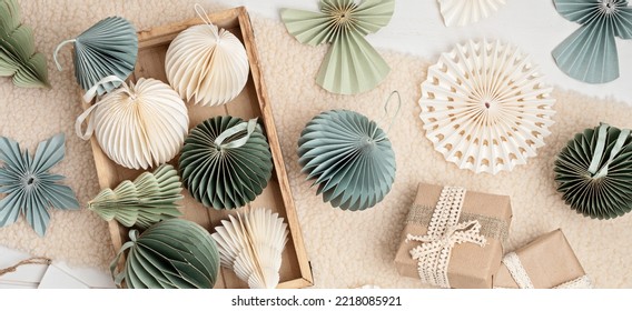 Scandinavian christmas paper honeycomb ornaments in the box and gifts. Modern sustainable christmas decoration, minimalist and plastic free. Top view, flat lay - Powered by Shutterstock