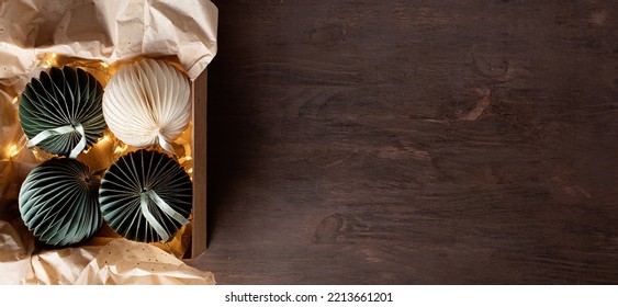 Scandinavian Christmas Paper Ornaments In The Box Over Wooden Background. Modern Christmas Decoration, Minimalist And Plastic Free. Top View, Flat Lay