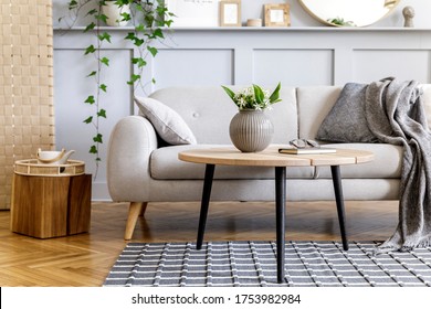Scandinavian concept of living room interior with design sofa, coffee table, plant in pot, lamp, carpet, plaid, pillow, shelf, decoration and personal accessories in modern home staging.