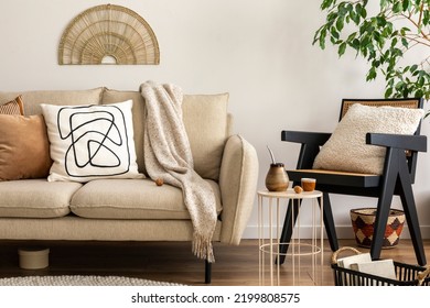 Scandinavian and cozy interior of living room with design beige sofa, pillows, side tables, plants, bamboo ladder, carpet, decoration and personal accessories. Stylish home decor. Template.	